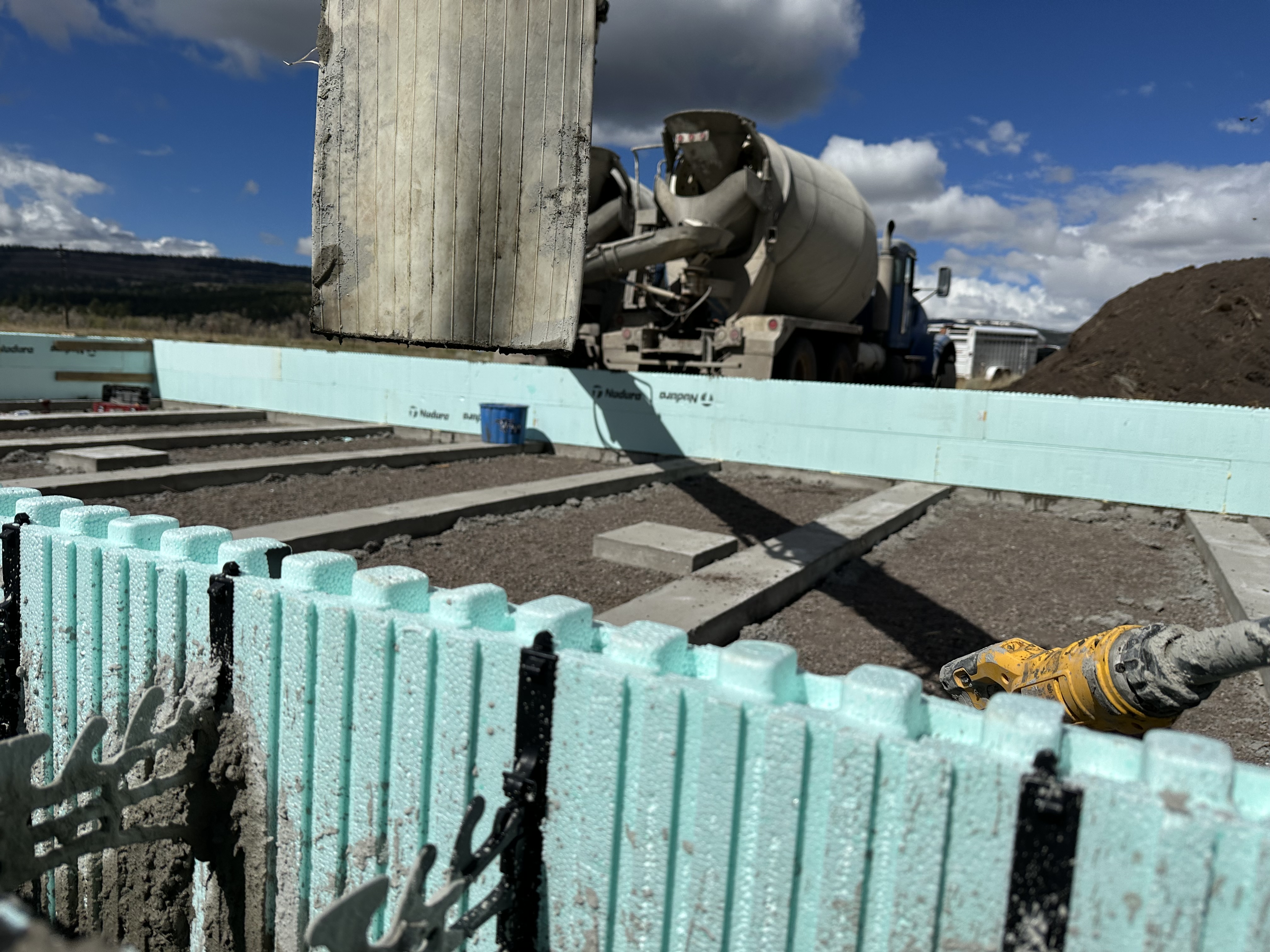 ICF foundation pour with mixer truck and mountains in the San Luis Valley
