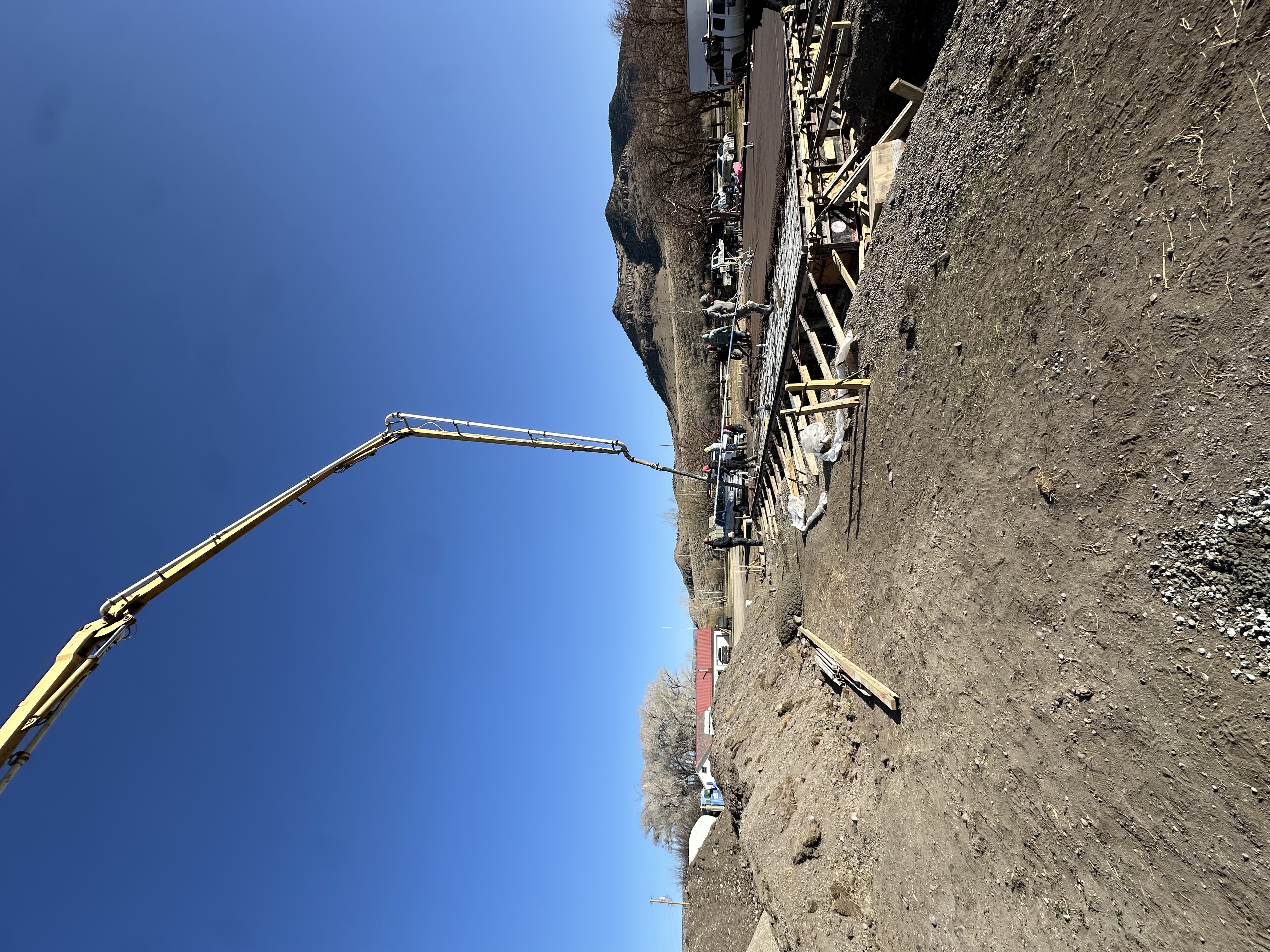 Pump truck boom reaching over a slab pour